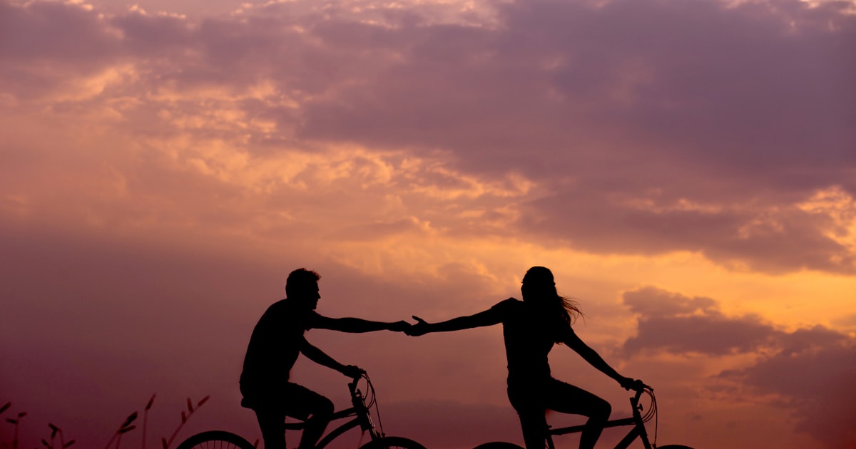 Couple looking in different directions on a bridge