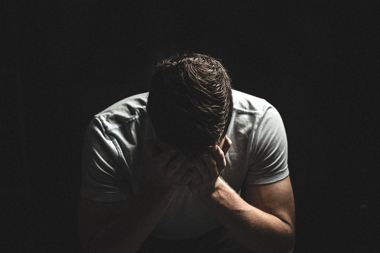 Man sitting alone in darkness
