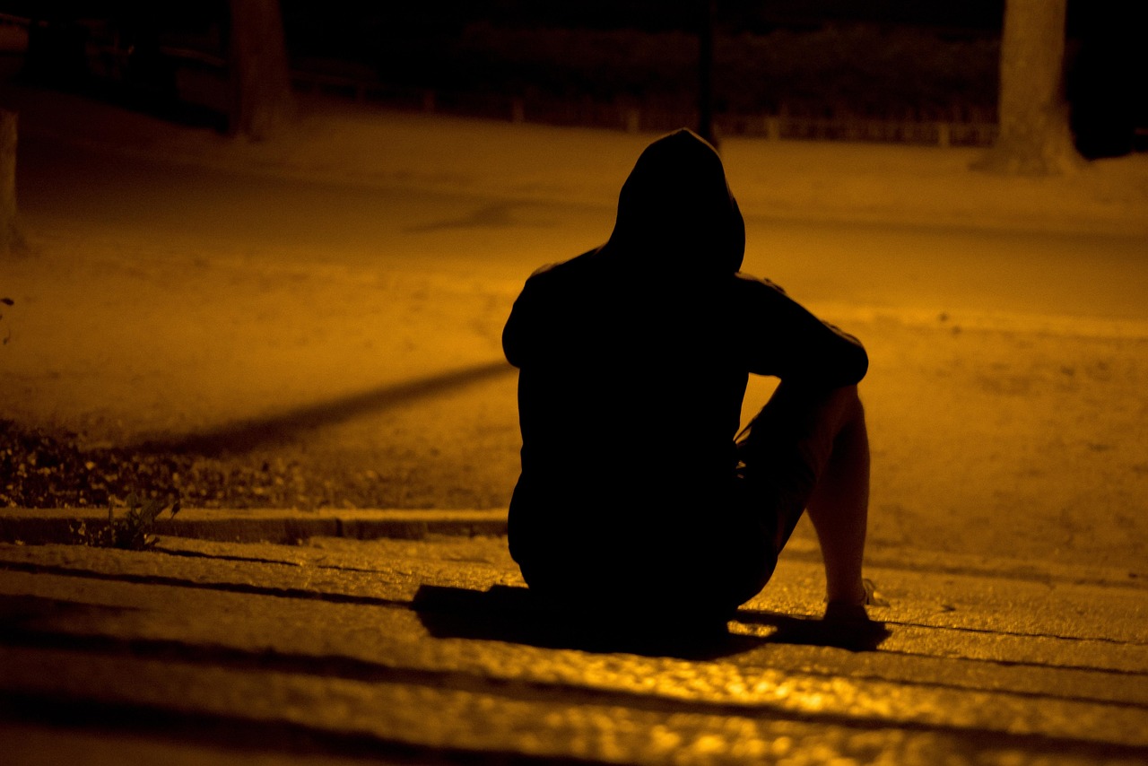 Man sitting alone at night contemplating